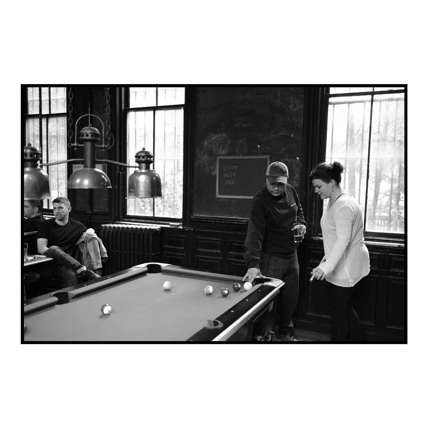 Some friends playing pool in a bar