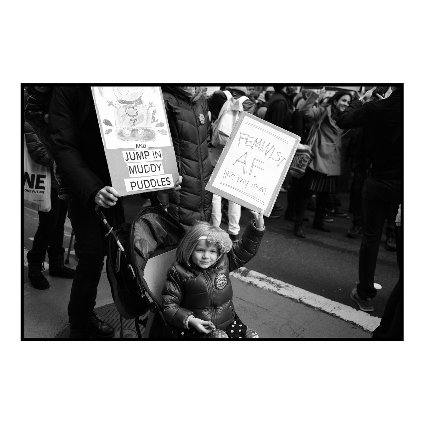 Girl holding a sign reading Feminist AF