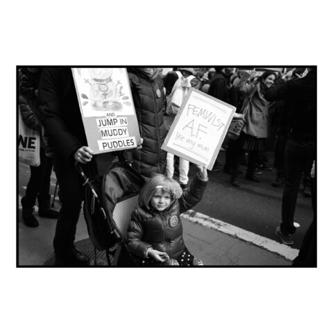 Girl holding a sign reading Feminist AF