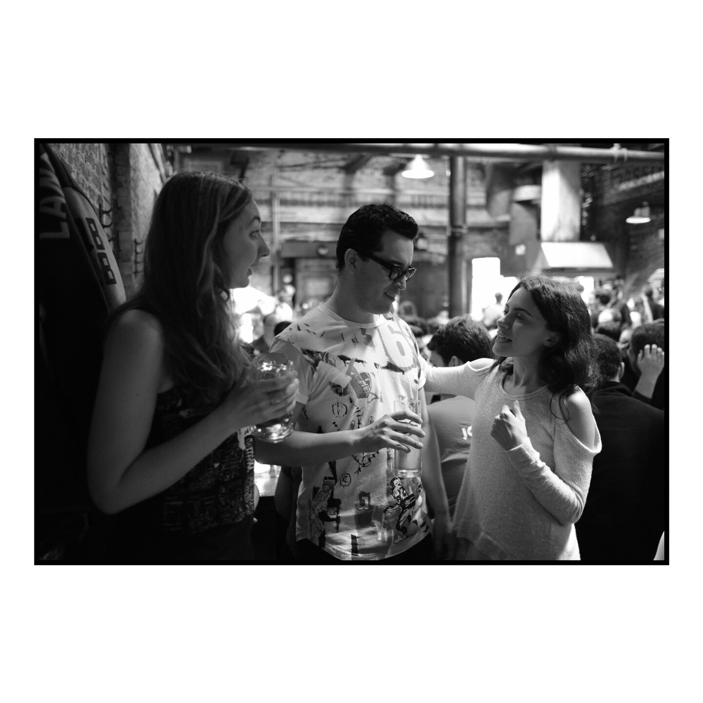 Three friends socializing at a bar.