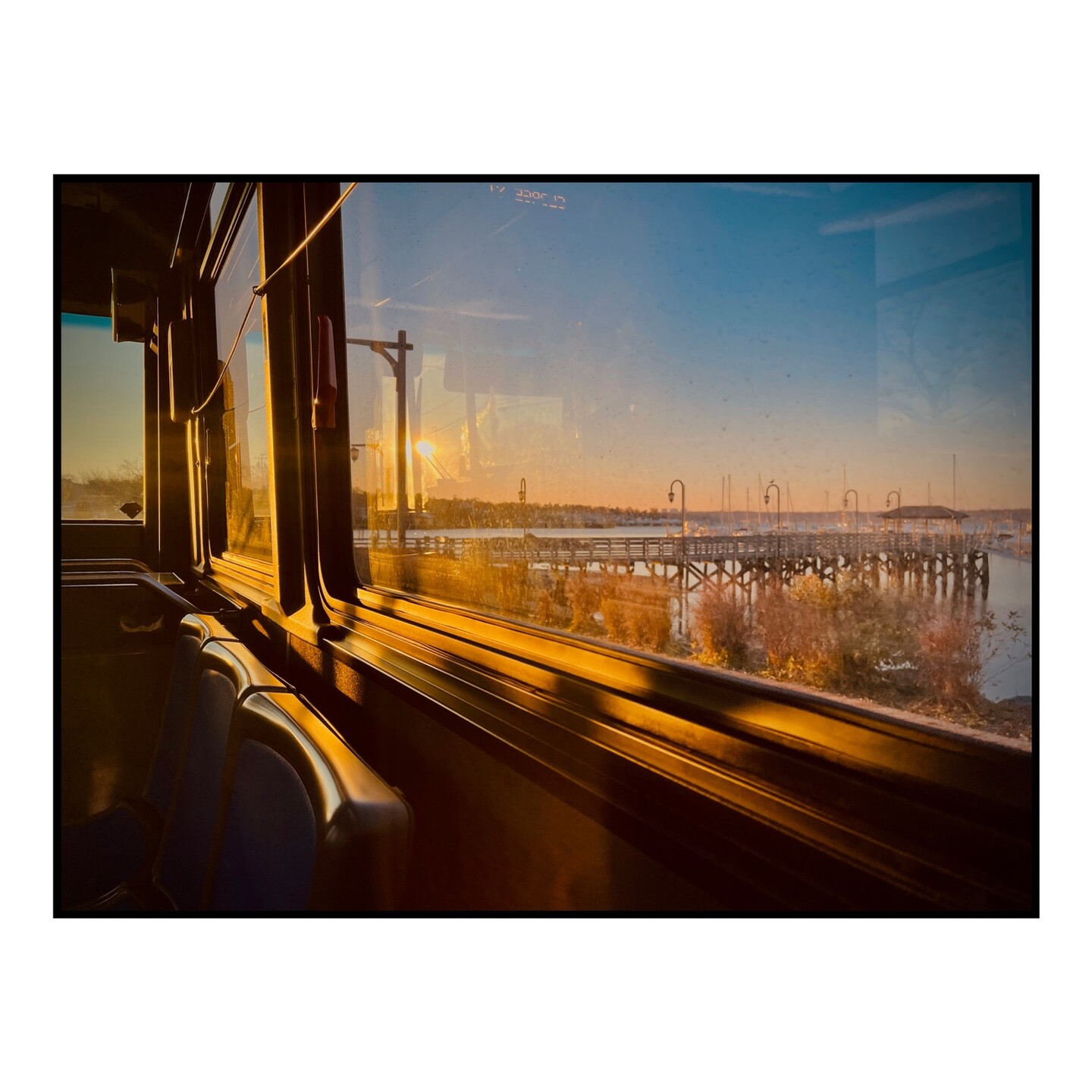 A view through the window of a city bus.
