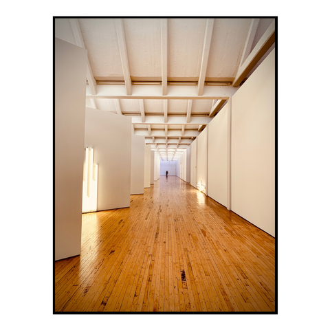 A hallway at Dia:Beacon with hardwood floors and white walls.