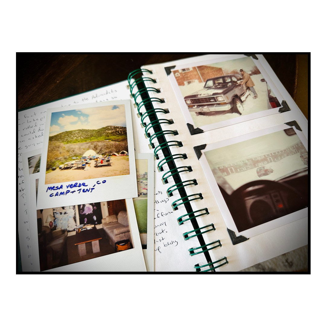 A journal and Polaroid prints payed out on a table