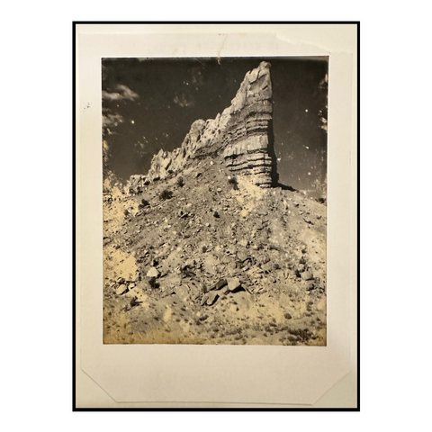 Image of a old weathered Polaroid photo of a land mass in the Southwest.