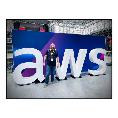 Me standing in front of a giant AWS sign at the Jacob Iavits center in NYC