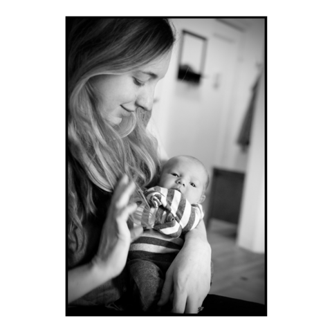 A woman holding a newborn baby